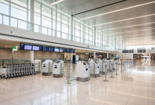 Modern airport arrivals hall with digital kiosks and signage, contemporary design