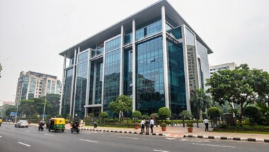 Modern tech office building in Bengaluru with street traffic and pedestrians