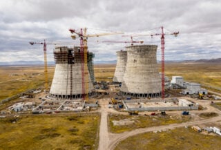 Nuclear power plant construction site with cooling towers in Central Asian steppe landscape