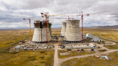 Nuclear power plant construction site with cooling towers in Central Asian steppe landscape