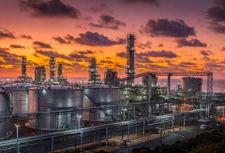 Oil refinery and storage tanks at dusk, Australia