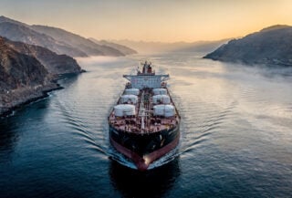 Oil tanker in Strait of Hormuz waterway, Iran-Oman passage, dawn light