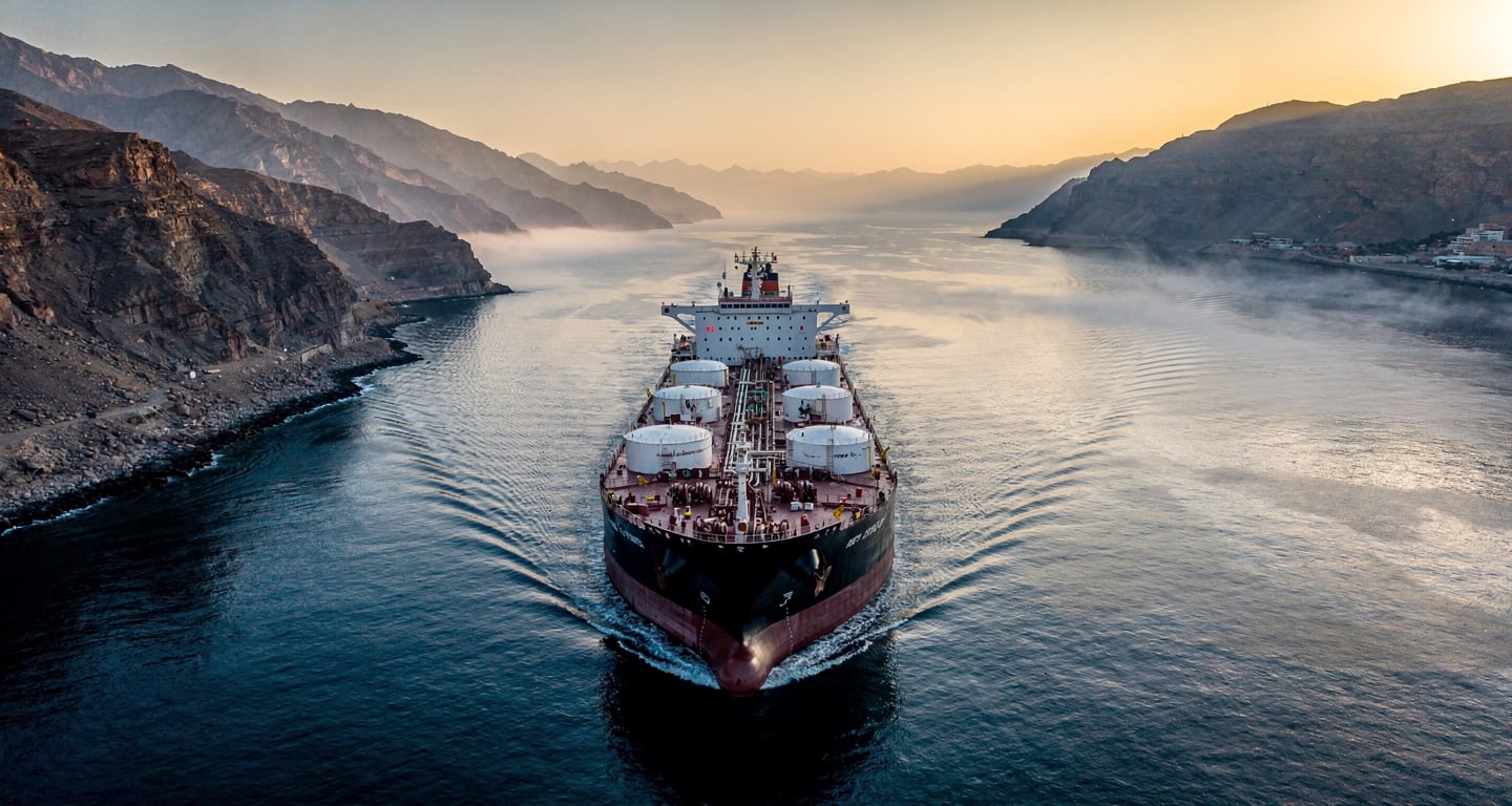 Oil tanker in Strait of Hormuz waterway, Iran-Oman passage, dawn light