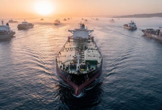 Oil tanker in Strait of Hormuz shipping lane, dawn light, aerial view