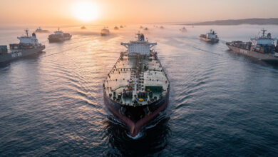 Oil tanker in Strait of Hormuz shipping lane, dawn light, aerial view