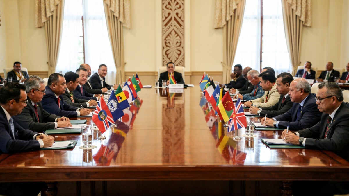 Pacific Island leaders at regional summit meeting, formal diplomatic setting with national flags