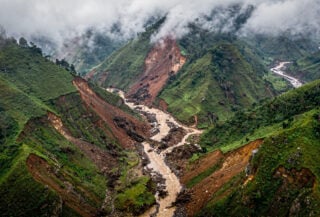 Saturated mountain slopes in Lai Chau province, northern Vietnam, showing landslide damage and debris flows