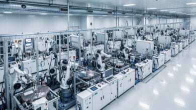 Advanced semiconductor fabrication plant interior, rows of precision chip-making equipment under industrial lighting