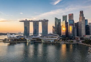 Singapore financial district skyline at dusk with modern glass towers and Marina Bay