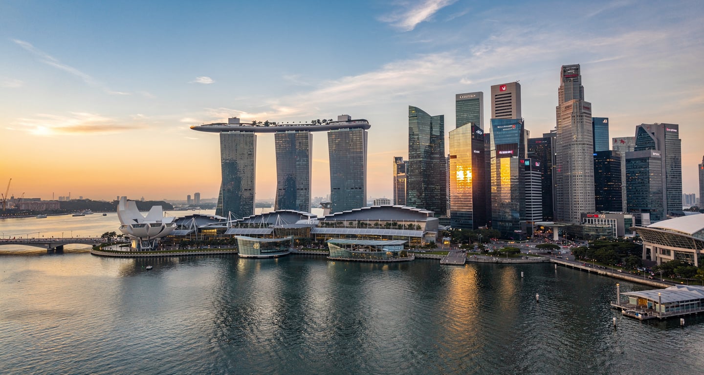 Singapore financial district skyline at dusk with modern glass towers and Marina Bay