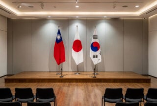 Taipei conference hall stage with Taiwan, Japan, South Korea flags displayed