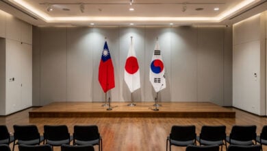 Taipei conference hall stage with Taiwan, Japan, South Korea flags displayed