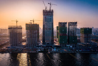 Tianjin skyline with Goldin Finance 117 skyscraper under construction, cranes visible, dusk lighting