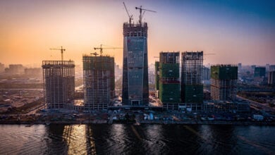 Tianjin skyline with Goldin Finance 117 skyscraper under construction, cranes visible, dusk lighting