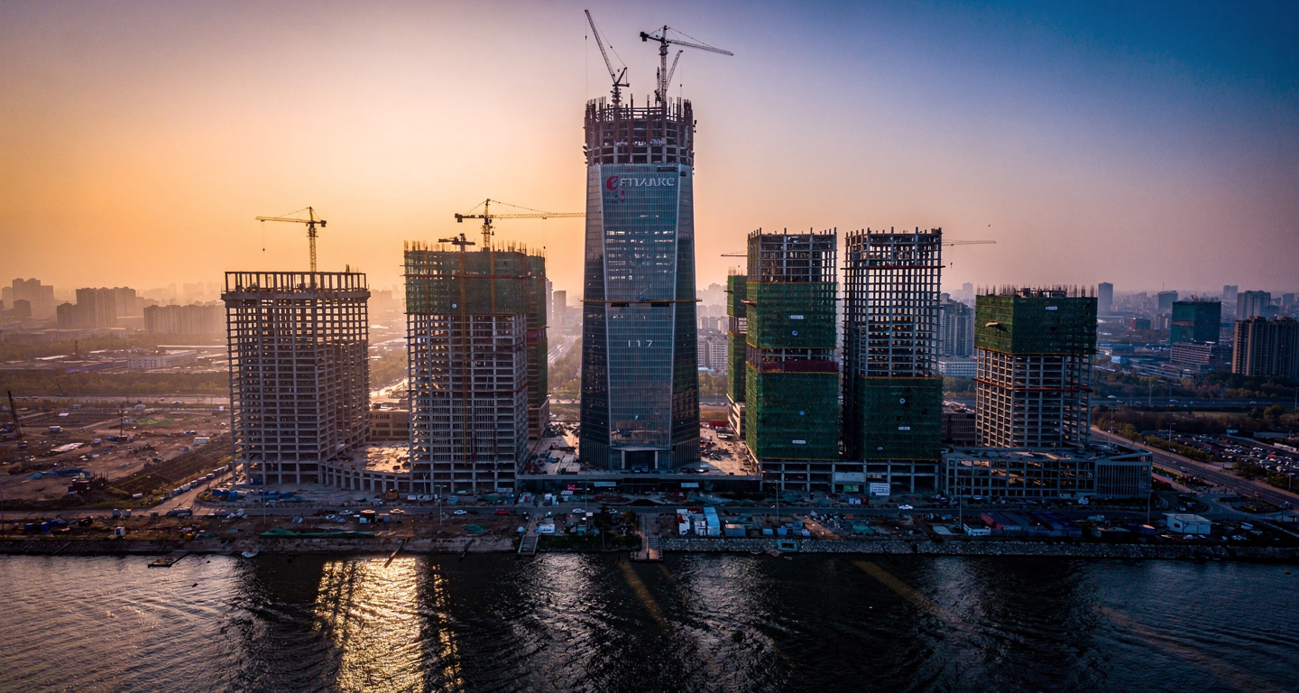 Tianjin skyline with Goldin Finance 117 skyscraper under construction, cranes visible, dusk lighting