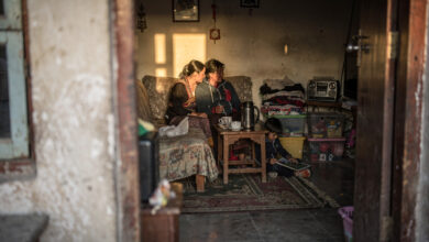 Young family in modest Thimphu apartment, warm interior lighting, domestic scene