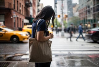 Young woman in contemplative moment on New York City street