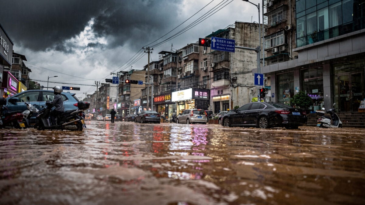 Flooded street in Shanghai during heavy rainfall, water rising against buildings