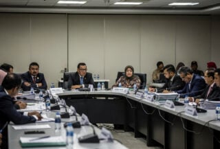 Malaysian political delegates in tense coalition talks during conference hall meeting