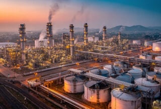 Oil refinery complex with distillation towers at dusk, Mumbai, India