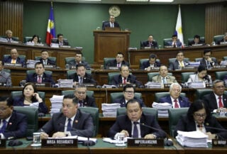 Philippine senators in formal session during impeachment hearing, Senate chamber, fluorescent lighting