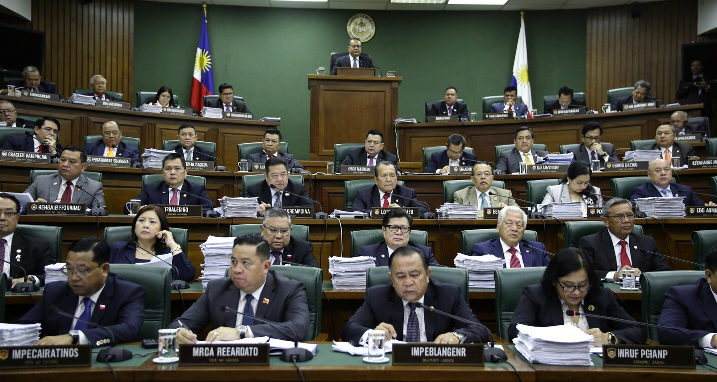Philippine senators in formal session during impeachment hearing, Senate chamber, fluorescent lighting