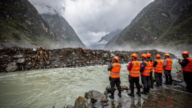 Rescue workers at debris-dammed barrier lake in Nepal-Tibet border Himalayan valley, monsoon conditions
