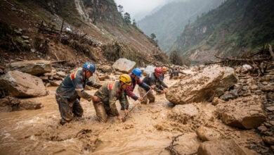 Rescue workers searching through debris in flood-ravaged Bhotekoshi River valley, Rasuwa district, Nepal