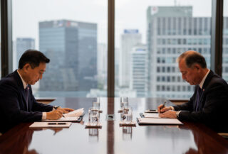 South Korean and U.S. defense ministers at bilateral meeting table in Seoul, reviewing documents