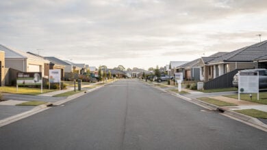 Suburban street with residential homes and for-sale signs, Brisbane, Australia