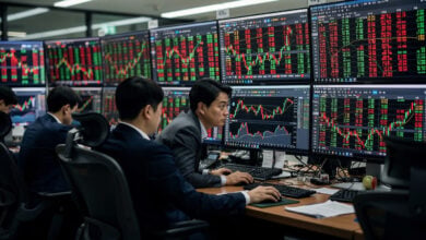 Traders watching stock screens in Seoul dealing room, monitoring semiconductor rally