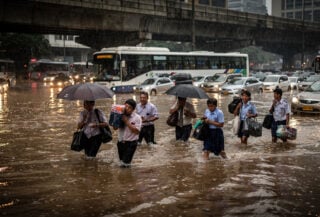 Commuters wading through floodwater on Manila's EDSA during heavy monsoon rainfall