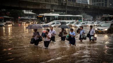 Commuters wading through floodwater on Manila's EDSA during heavy monsoon rainfall