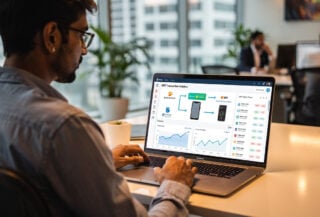Developer reviewing UPI payment dashboard on laptop screen in Mumbai office