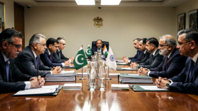 Diplomats from India and Pakistan at a formal negotiation table, tension evident in their body language