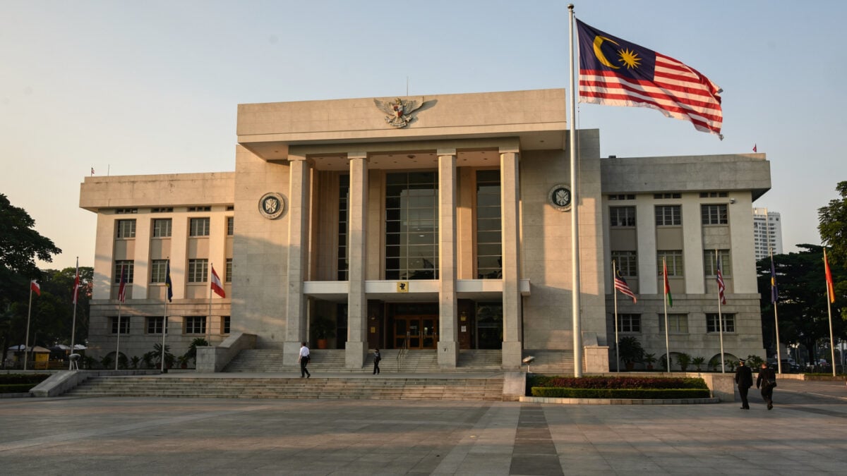 Kuala Lumpur Sessions Court building exterior, Malaysian flag, morning light