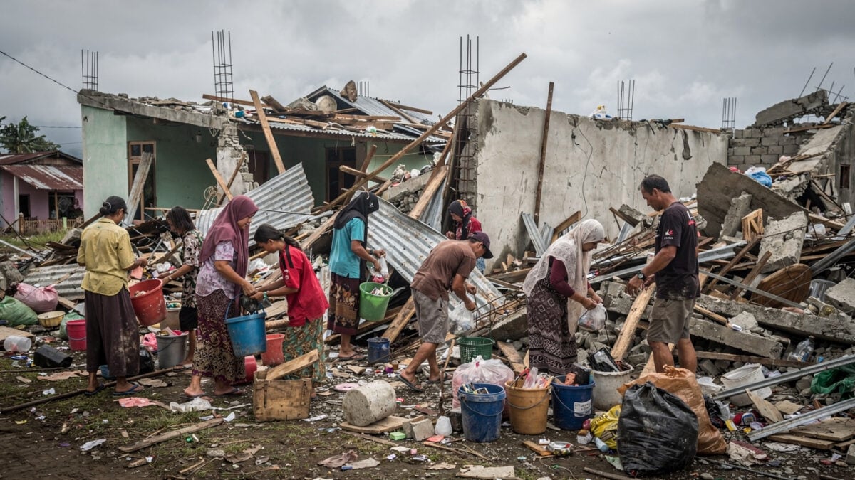 Residents sorting through rubble of collapsed homes in Nagekeo, East Nusa Tenggara, Indonesia
