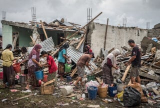 Residents sorting through rubble of collapsed homes in Nagekeo, East Nusa Tenggara, Indonesia