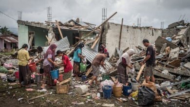 Residents sorting through rubble of collapsed homes in Nagekeo, East Nusa Tenggara, Indonesia