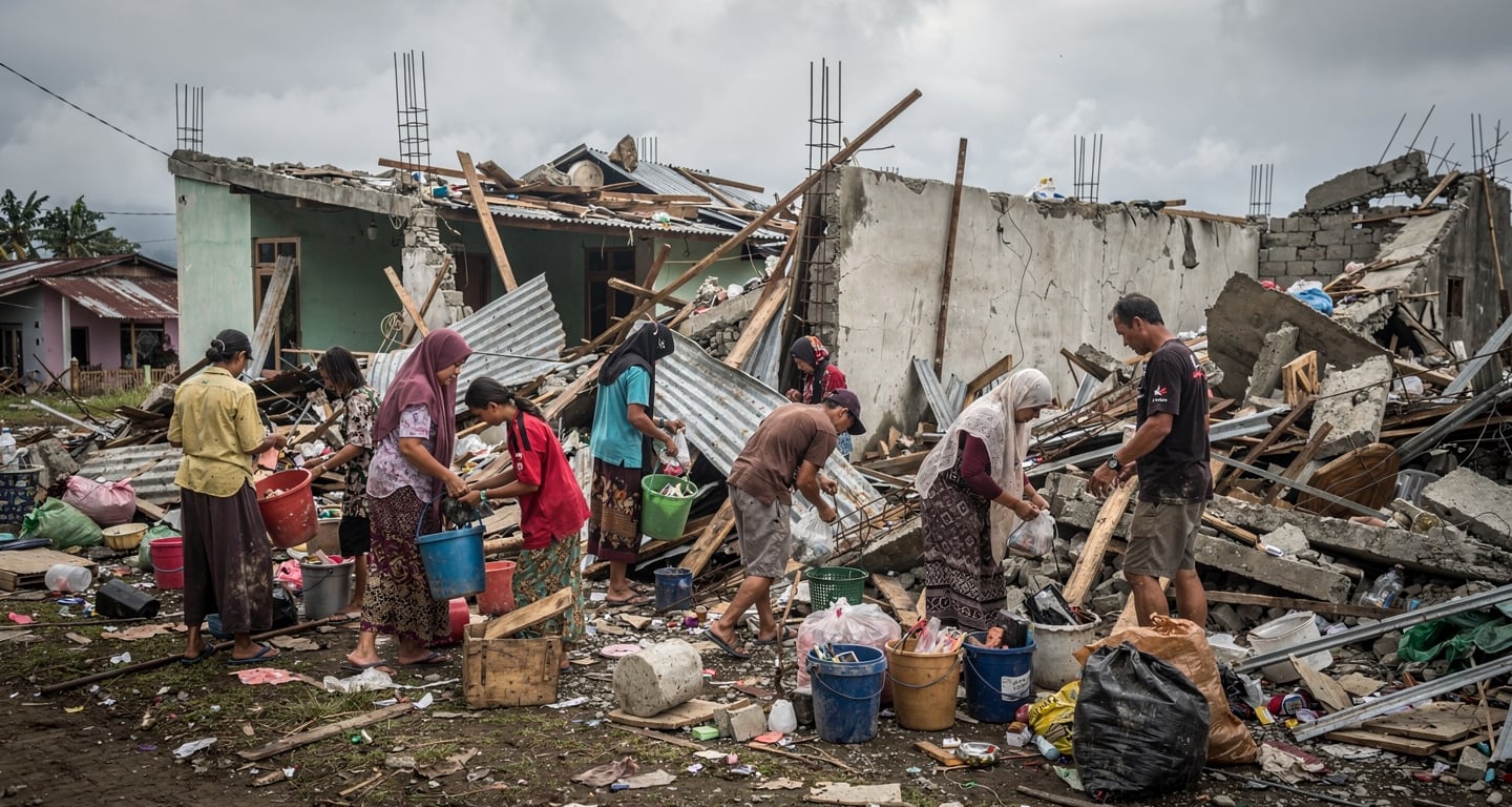 Residents sorting through rubble of collapsed homes in Nagekeo, East Nusa Tenggara, Indonesia