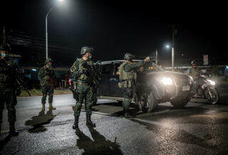 Thai soldiers manning nighttime checkpoint in Narathiwat after coordinated attacks