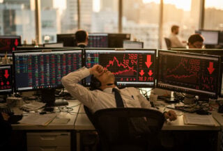 Tokyo traders monitoring red market indices on screens as yen strengthens, dealing room afternoon light
