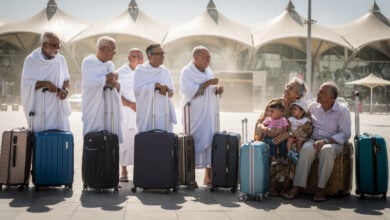 Elderly pilgrims waiting with suitcases outside Jeddah Hajj Terminal