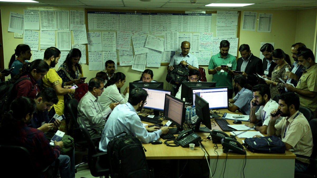 Indian consular staff and travellers in crowded Riyadh control room