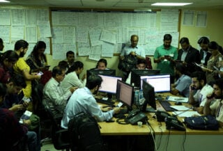 Indian consular staff and travellers in crowded Riyadh control room