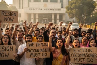 Protesters with placards demanding resignation outside Election Commission headquarters, New Delhi